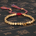 Hand-woven adjustable alloy tassel bracelet in electroplated colour T131 on neutral background