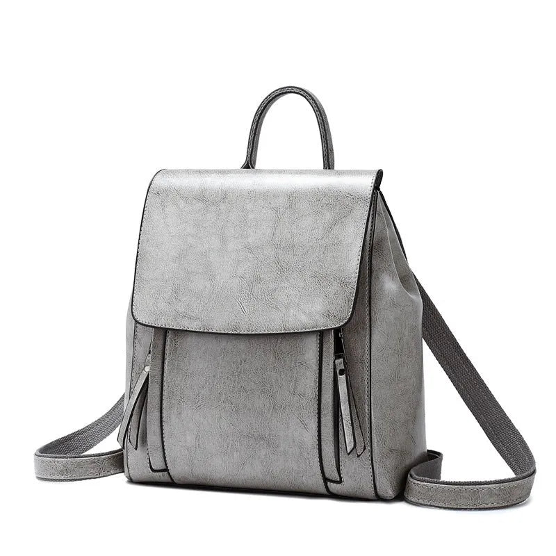 Large black genuine leather women's backpack with multiple pockets and dual straps.