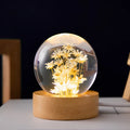 Luminous 3D dandelion crystal ball LED desk light on a beech wood stand.