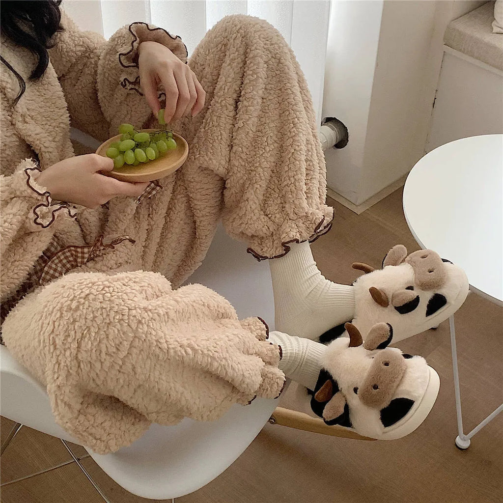White cow-themed plush slippers for women with non-slip textured soles
