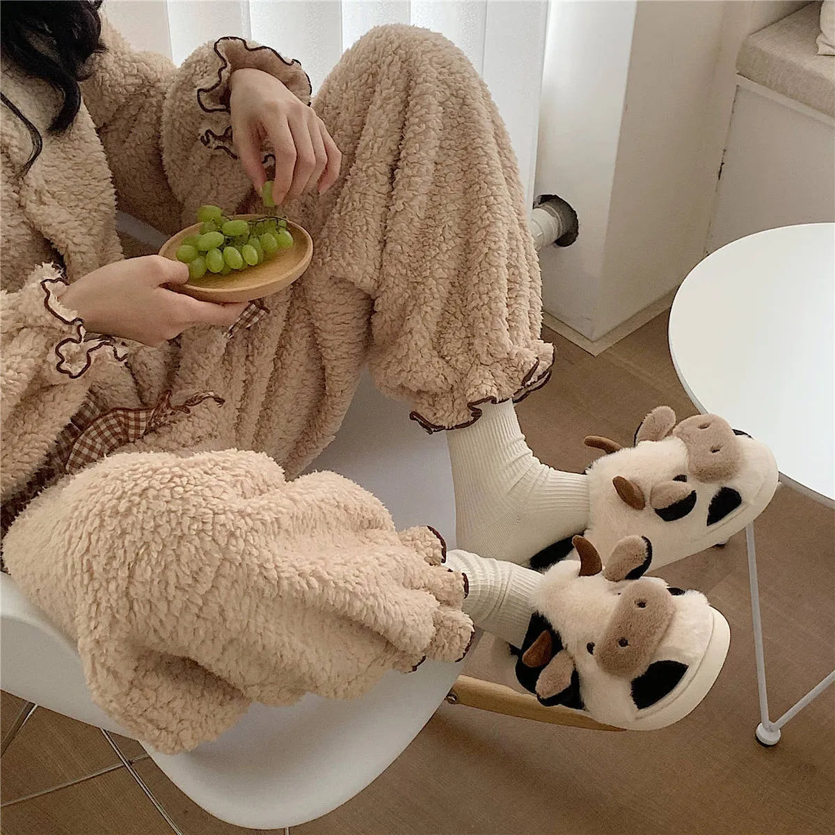 White cow-themed plush slippers for women with non-slip textured soles