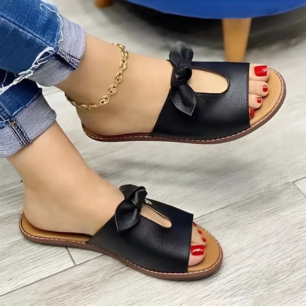 Ladies fish mouth sandals with a decorative bow on the upper, shown in black, pink, and gold colours.