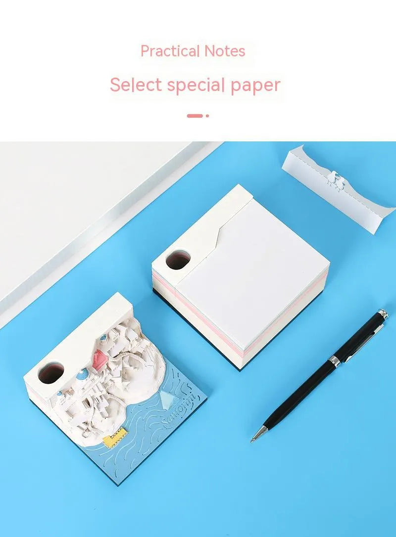 Assembled Santorini beach 3D paper model notepad with decorative lighting on a desk.