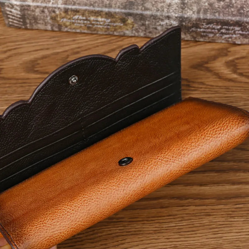 Brown tri-fold women's wallet with Chinese floral embossed pattern on cowhide leather.