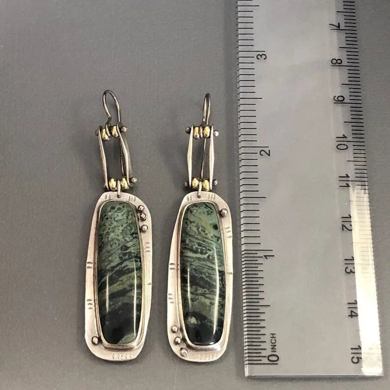 A pair of women's geometric-shaped alloy earrings with a two-tone marble pattern finish.