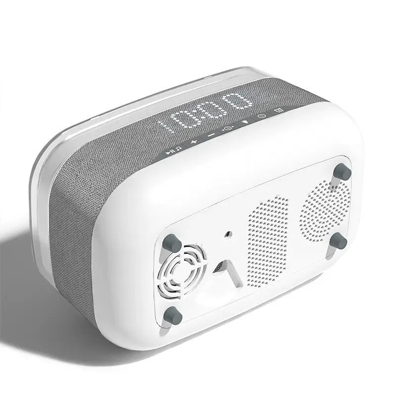 White multifunctional alarm clock with Bluetooth speaker and wireless charging pad on a table