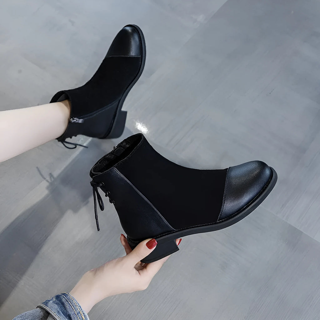 Black women's above-the-knee Martin boots with a side zipper, round toe, and decorative bow.