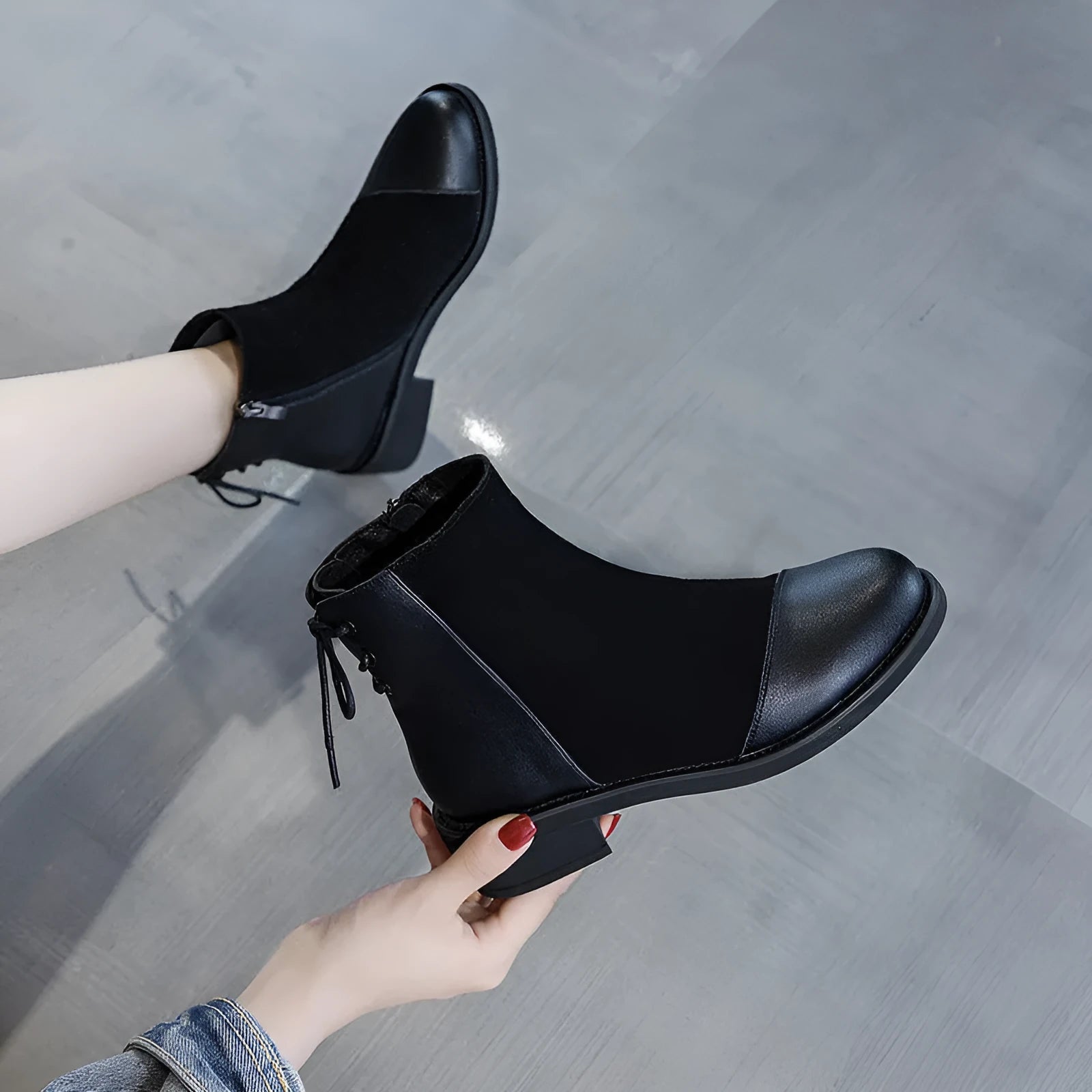 Black women's above-the-knee Martin boots with a side zipper, round toe, and decorative bow.