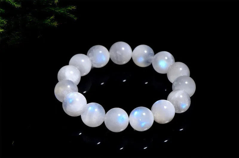 Natural blue moonstone round beads strung on a white cord bracelet.