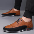 Men's black leather-toe casual shoes with fabric upper and rubber sole on a plain background.