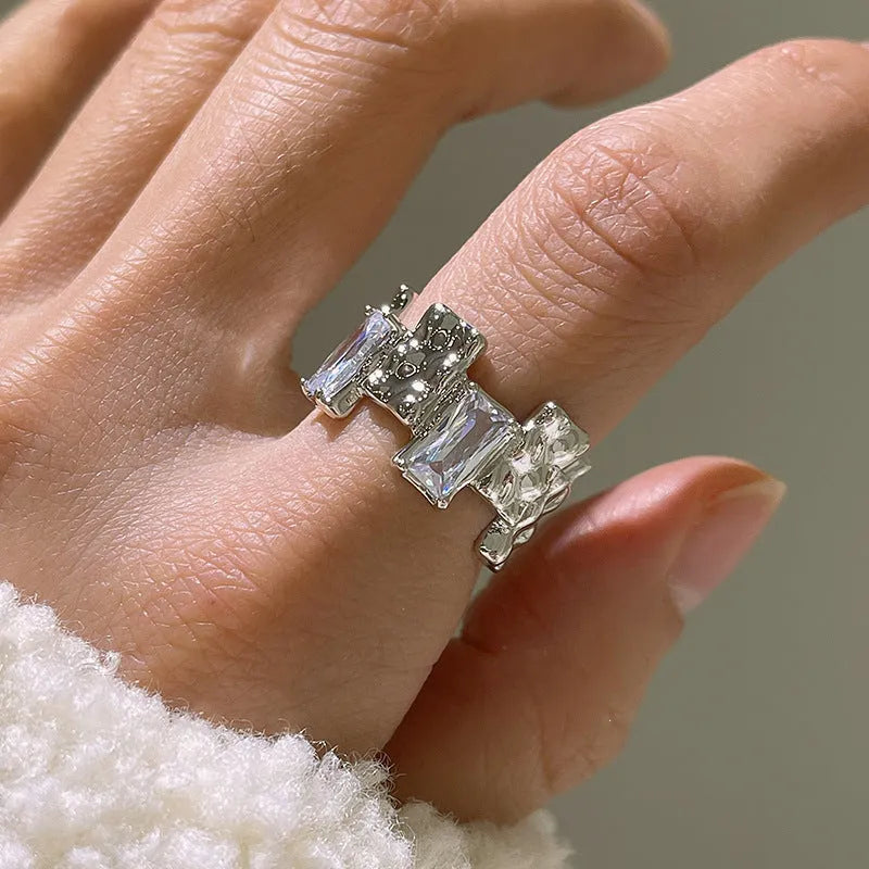 Silver geometric ring with cross zircon detailing and open gemstone setting