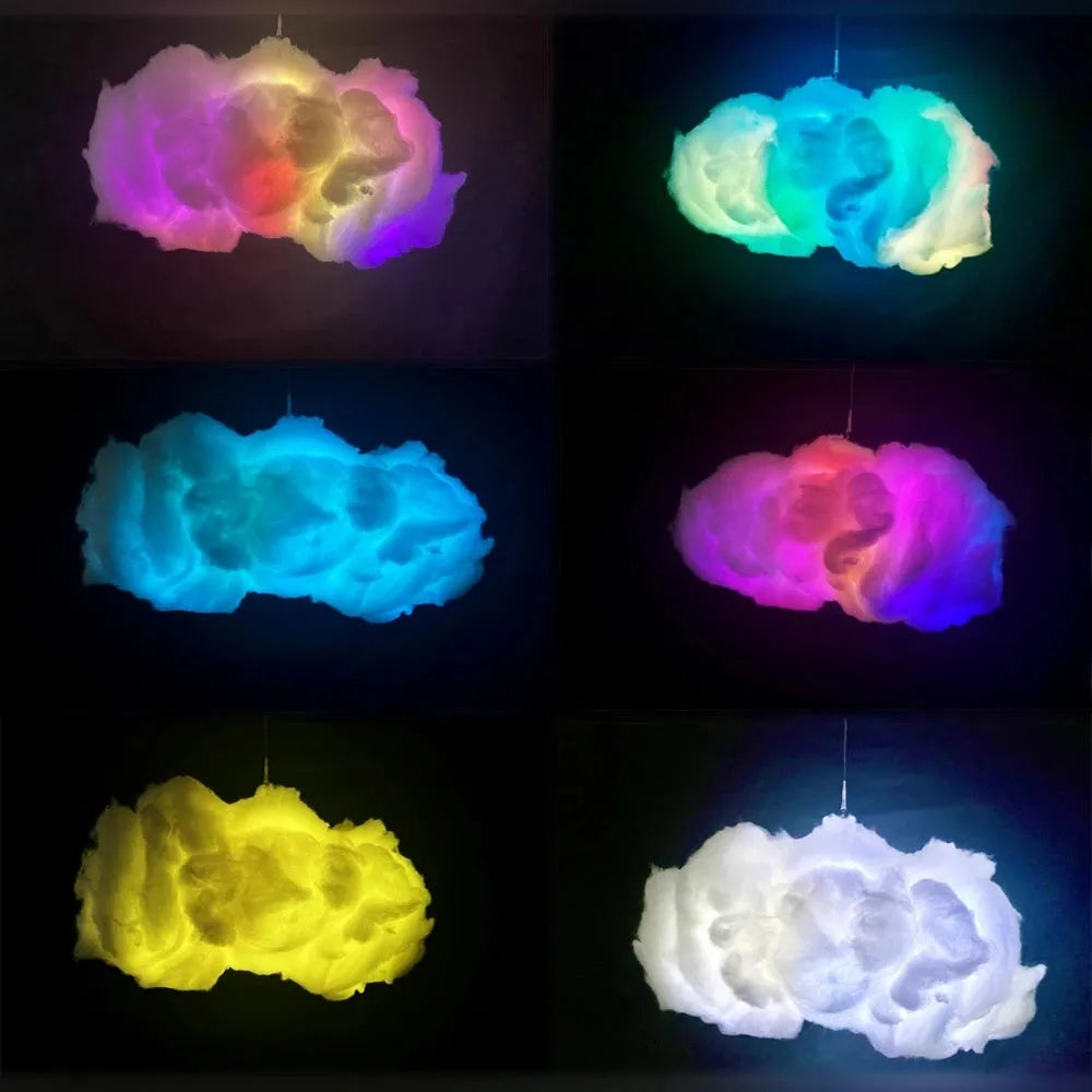 White fabric cloud shaped ambient light with colourful LED lighting, hanging from ceiling with USB cable.