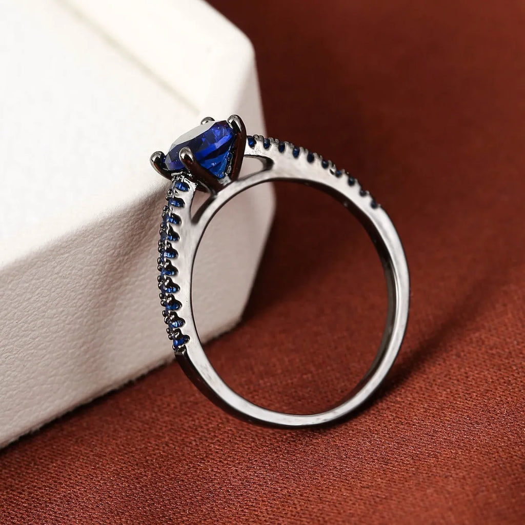 A hexagonal zircon fashion ring made from copper, shown in an electroplated gold rose red finish.