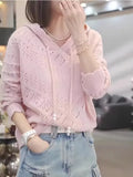 A woman's loose-fit, hooded longsuit undershirt with a textured crochet knit pattern and long sleeves.