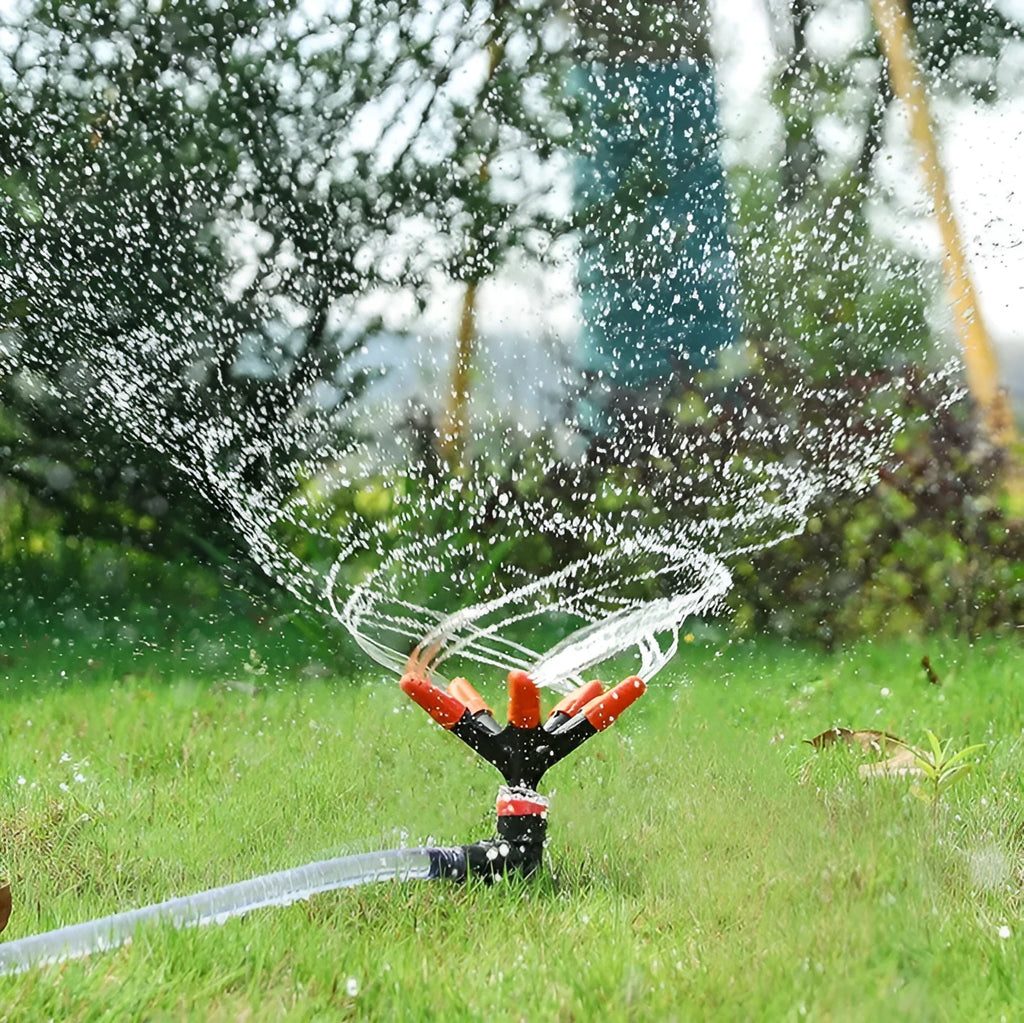 Orange plastic garden insert sprinkler with rotating water spray nozzle, 14x26.5cm