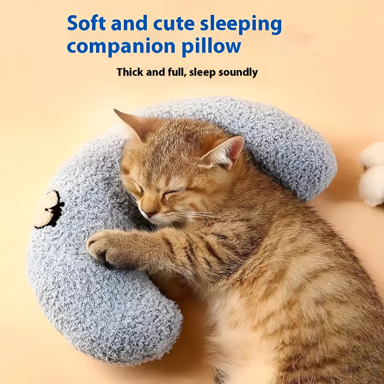 Blue cloth cat sleeping mat with a U-shaped neck pillow in a question mark style.