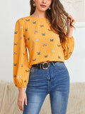 Women's green loose-fit long sleeve shirt with a colourful butterfly print.