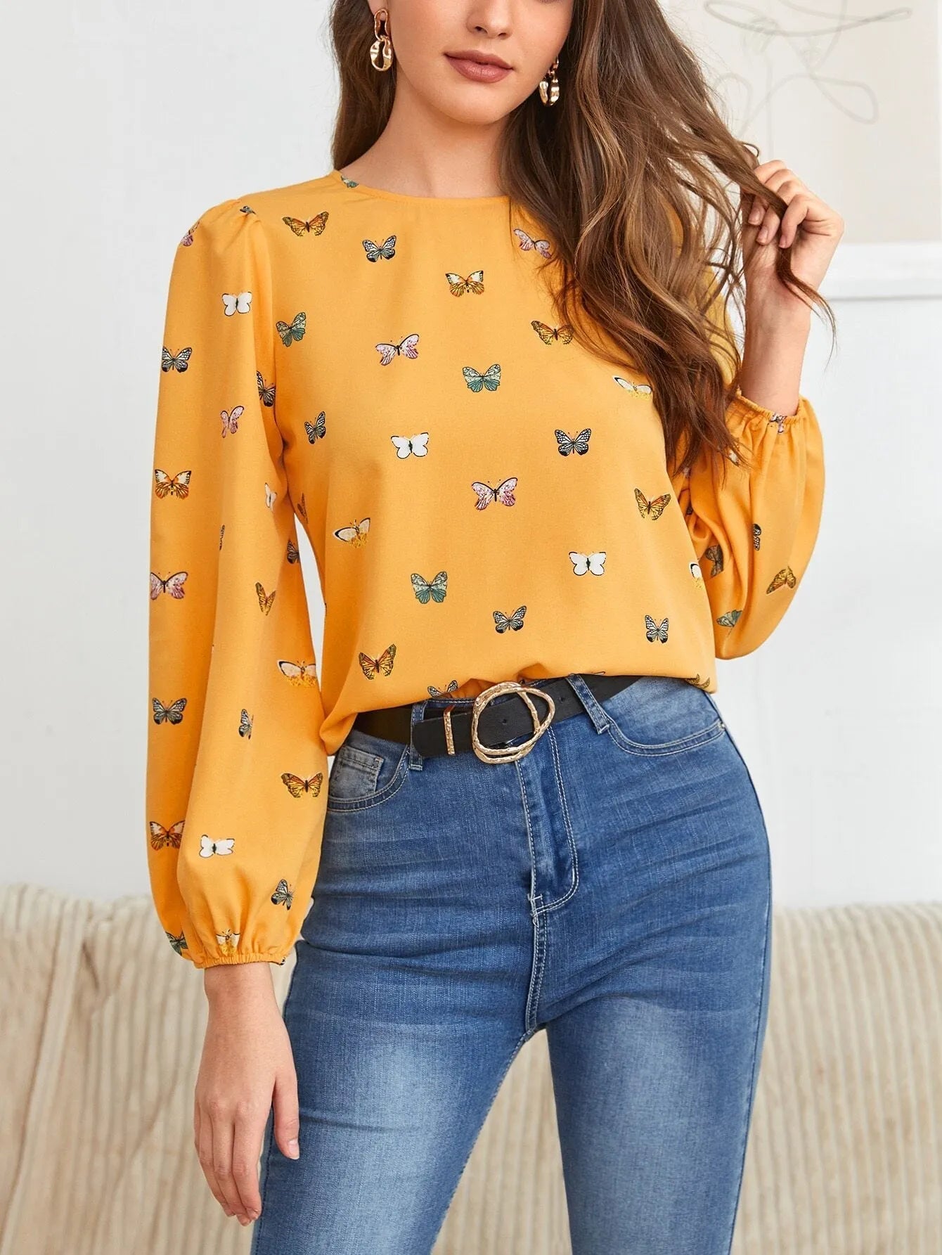 Women's green loose-fit long sleeve shirt with a colourful butterfly print.