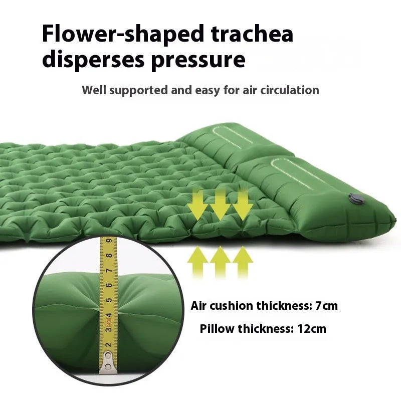Double size inflated air mattress in army green colour with an attached pillow, on a grass surface.