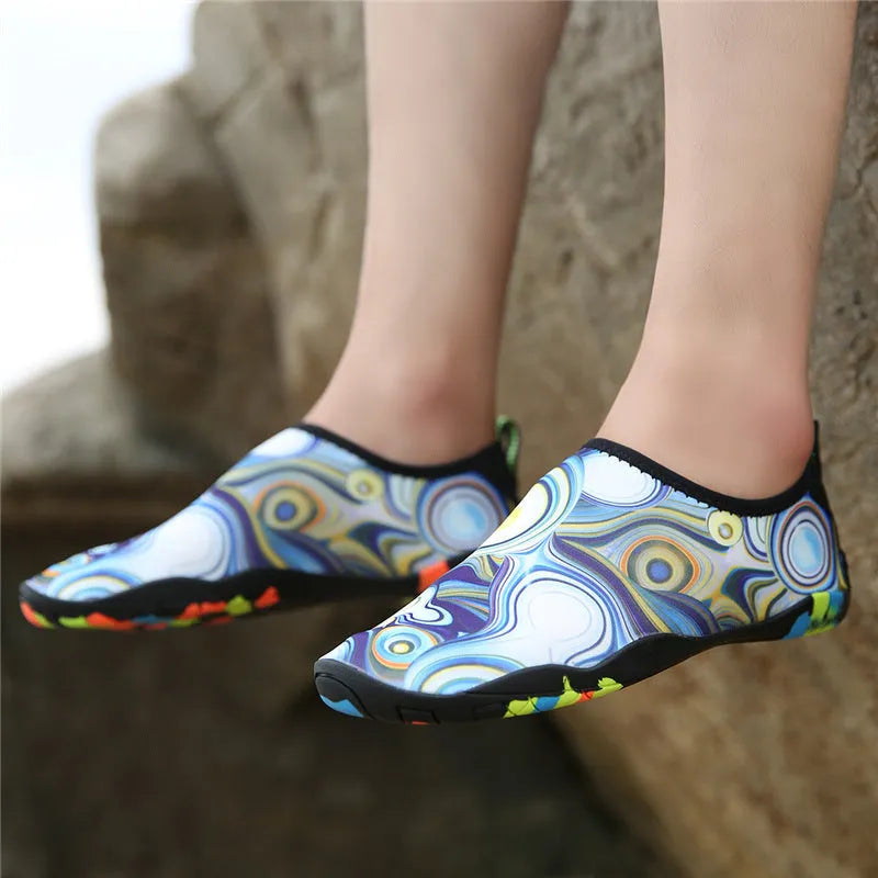 Lycra beach wading shoes with EVA midsole in blue, shown on a sandy shore.
