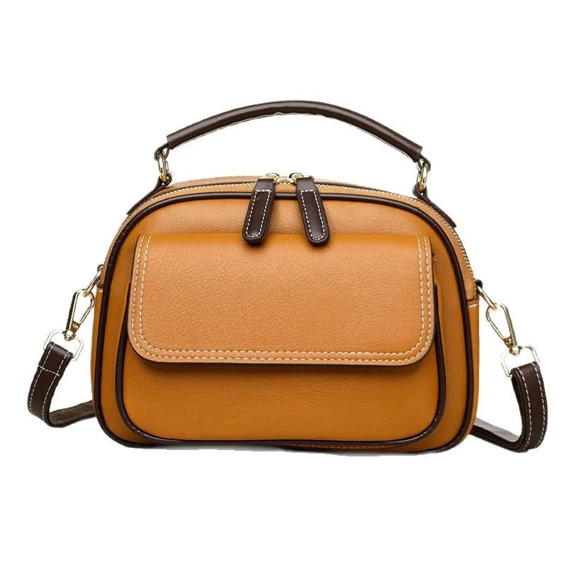 Women's black PU leather cross-body shoulder bag showing horizontal square shape and double straps