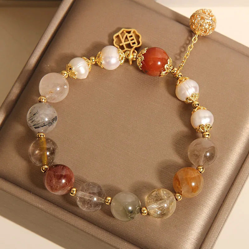 Women's crystal bracelet with colourful hair crystal beads, four pearls, and a Chinese Cai charm.