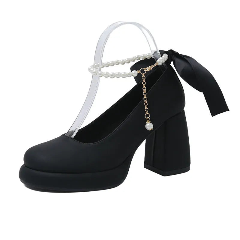 Beige women's Mary Jane shoes with chunky heel, ankle strap, pearl detail, and round toe.