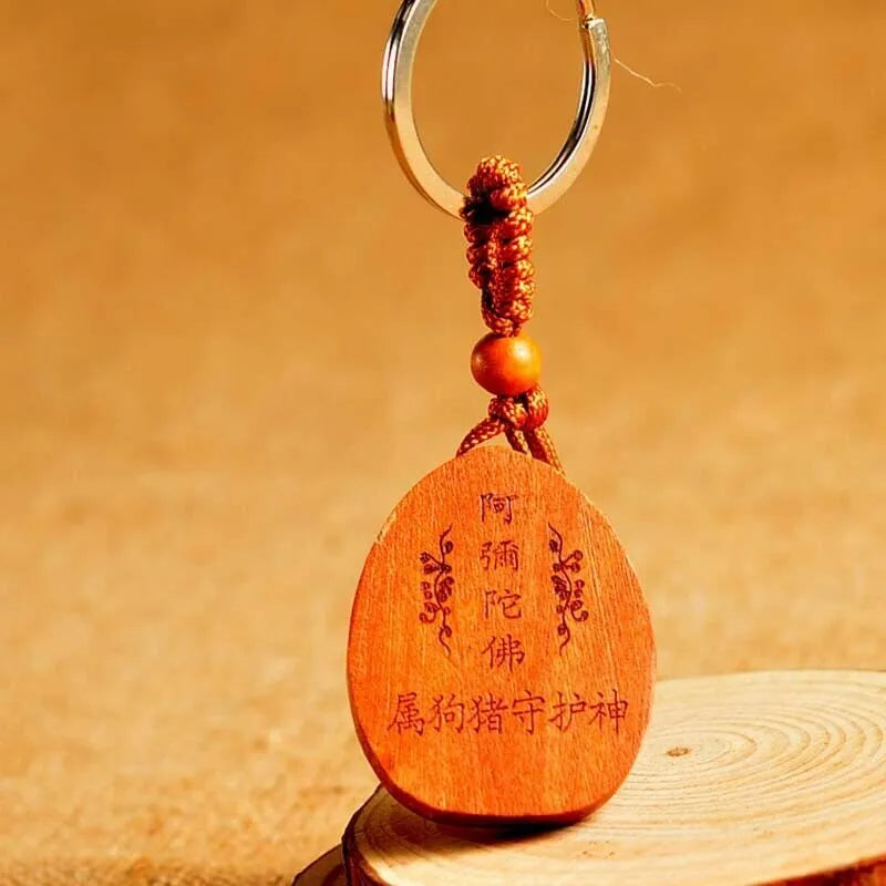 Eight patron saint keychains made of natural Taomu wood in orange colour, each measuring 10x3.2x4cm