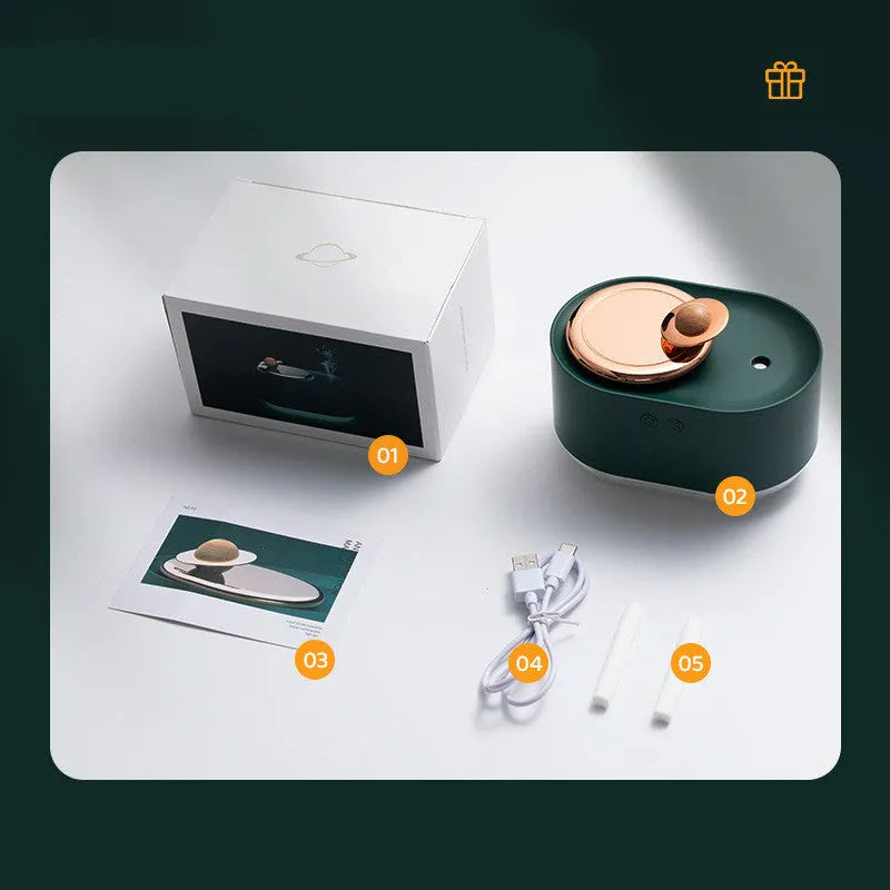 Green rotating planet-shaped USB humidifier with night light on wooden desk