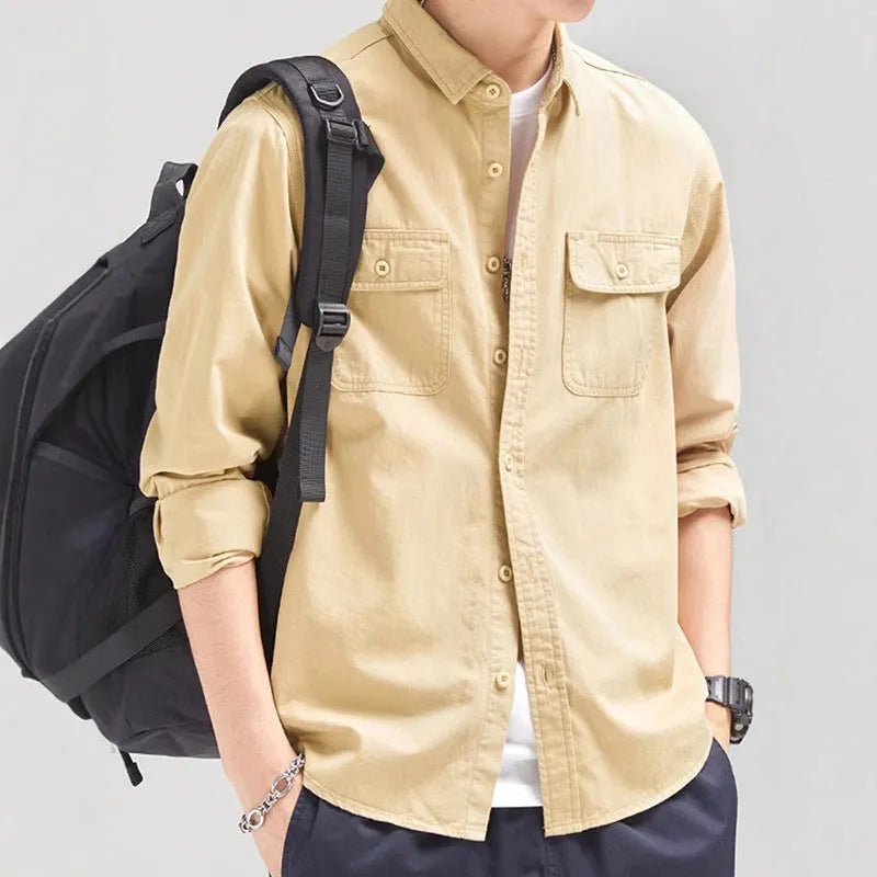 Man wearing a loose grey cardigan-style long sleeve shirt
