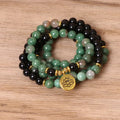 Green and black alloy bead elastic bracelet on a wrist.