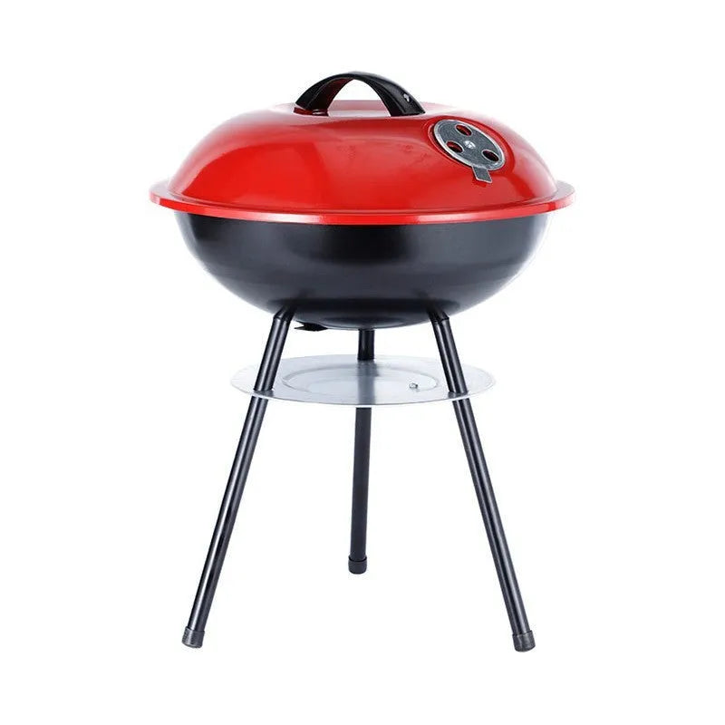 Portable iron barbecue oven with 14-inch apple stove design on a table outdoors.