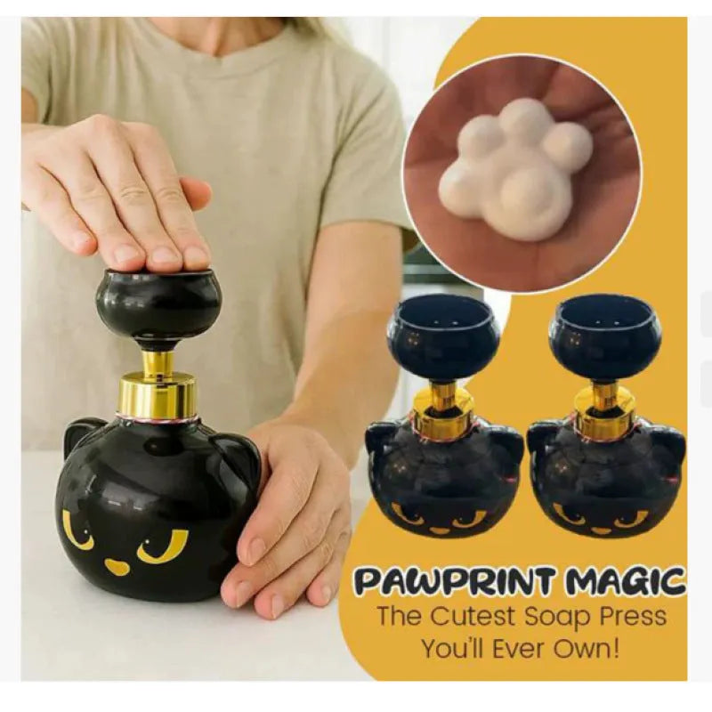 Black plastic cartoon cat shaped foam soap dispenser on a bathroom countertop.