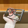 Transparent acrylic phone case for Samsung Galaxy with magnetic suction and invisible bracket, shown in black.