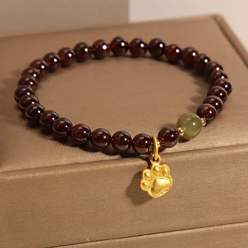 Cat's paw garnet crystal bracelet for women showing clear beads with feline charm