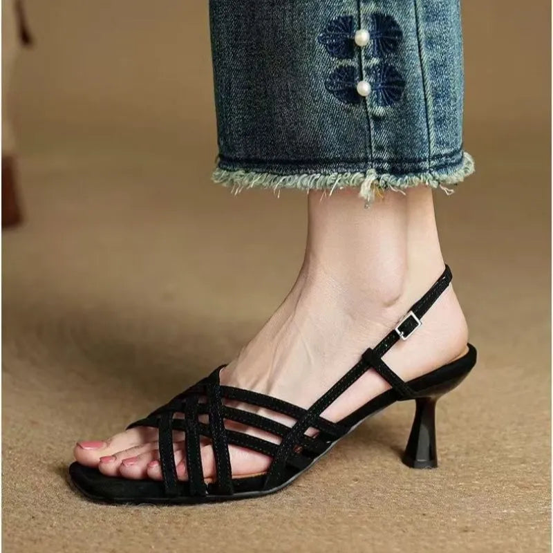 Retro light brown high heel sandals with thin cross straps and an ankle buckle on a square toe.