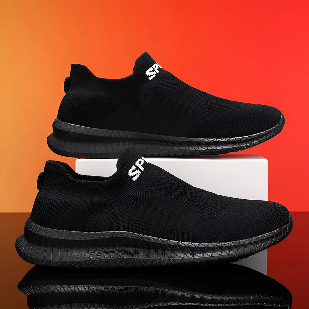 Men's lightweight Flyknit trainers in blue, shown from the side on a wooden deck.