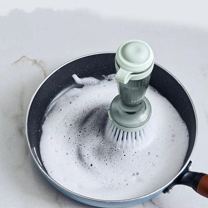 Pot and dish brush with soap dispenser, ergonomic handle, and replaceable brush head in mint green colour