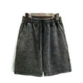 Men's cotton casual shorts in a loose straight-leg fit with distressed detailing, shown in a solid colour.