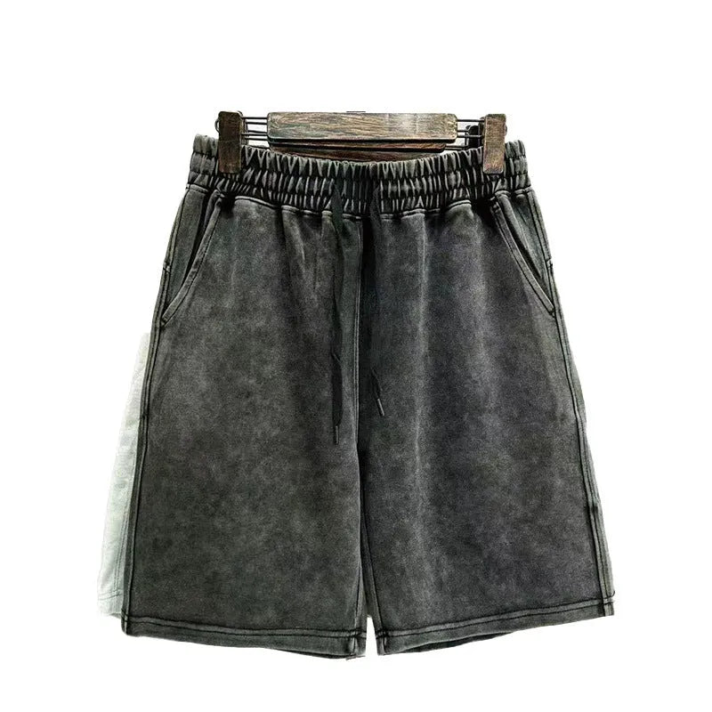 Men's cotton casual shorts in a loose straight-leg fit with distressed detailing, shown in a solid colour.
