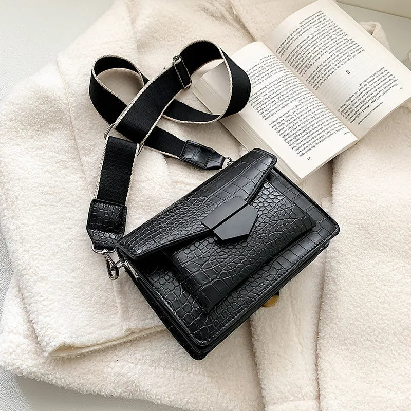 Vintage PU leather crossbody bag in black showing interior organisation for phones and wallets