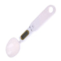 White digital spoon scale with LCD display showing weight measurement for kitchen ingredients