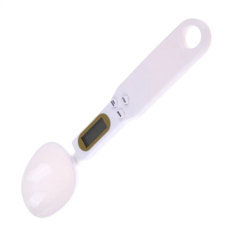 White digital spoon scale with LCD display showing weight measurement for kitchen ingredients