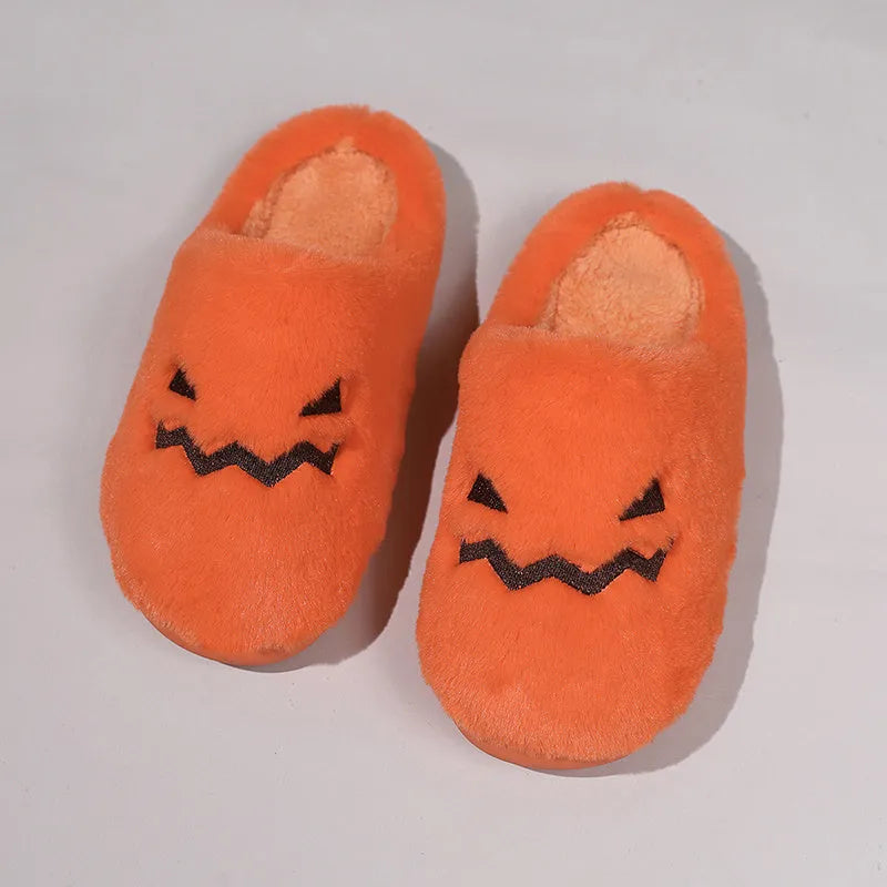 Orange Halloween pumpkin-themed plush indoor slippers with a coral velvet upper and non-slip PVC sole.