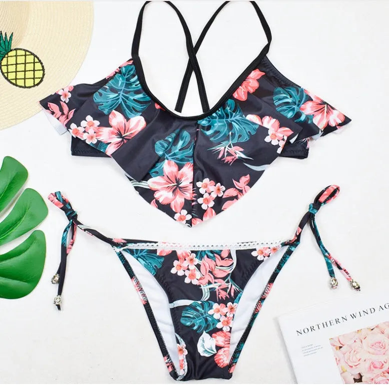 Black bohemian leaf print split bikini swimsuit with chest pad on display