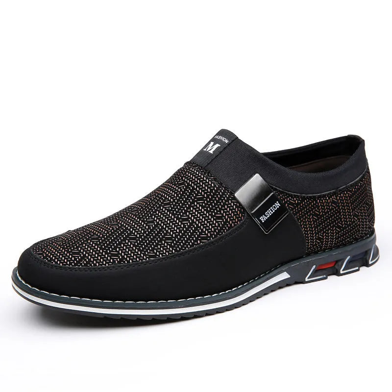 Men's synthetic leather slip-on casual shoe in black, showing square toe and flat rubber sole.