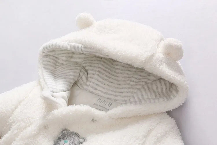 Cotton lamb baby winter romper suit in brown, showing long sleeves and feet covering.