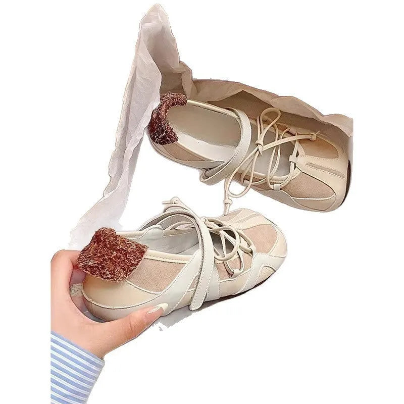 Women's beige vintage Mary Jane ballet shoes with lace-up front and a medium block heel.