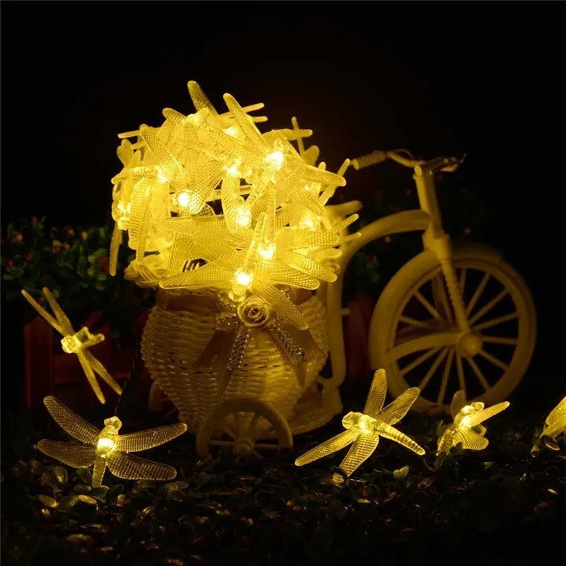 Outdoor solar-powered dragonfly string lights with 20 warm white LEDs on a 5 metre cable and IP65 waterproof rating