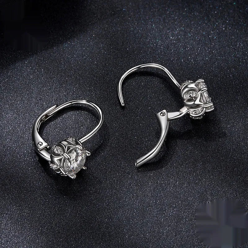 Sterling silver flower bud clip earring with moissanite stone and electroplated platinum finish.